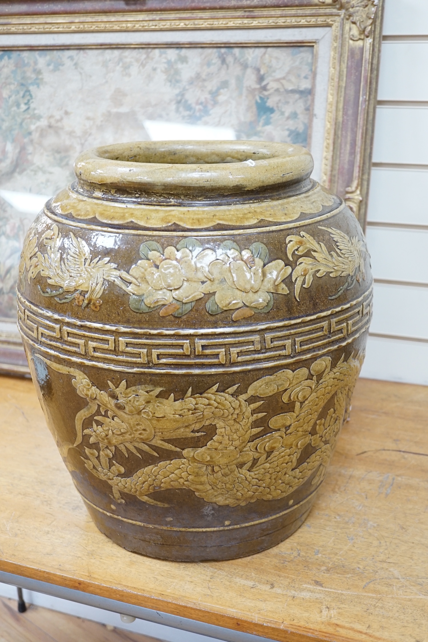 A large Chinese slip decorated ‘dragon and phoenix’ martaban vessel, decorated in relief, 47cm high